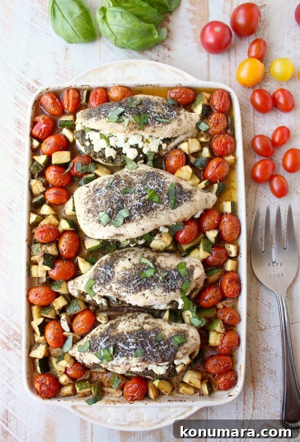 Sheet Pan Stuffed Chicken with Goat Cheese and Pesto 3 Close-up of stuffed sheet pan chicken with roasted vegetables