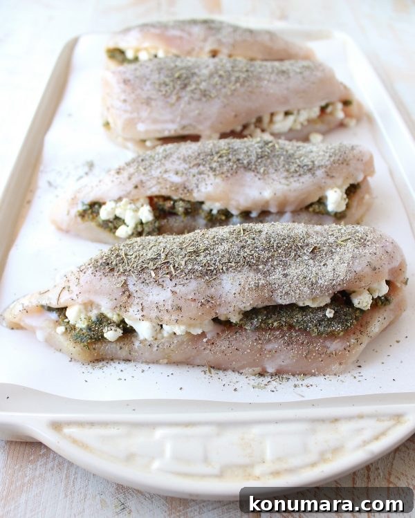 Sheet Pan Stuffed Chicken with Goat Cheese and Pesto 6 Chicken arranged on a sheet pan with vegetables