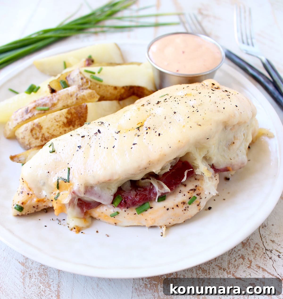 Reuben chicken is tossed with thousand island dressing, stuffed with sauerkraut & corned beef & topped with swiss cheese for a tasty, easy dinner recipe!
