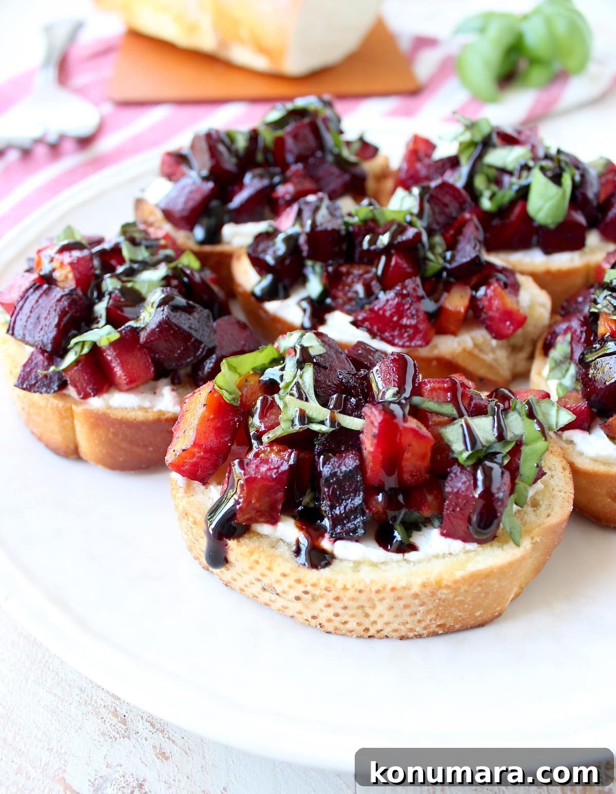 A toasted baguette is topped with goat cheese, balsamic roasted beets, fresh basil & balsamic reduction in this vegetarian Beet Bruschetta recipe that's perfect for Spring!