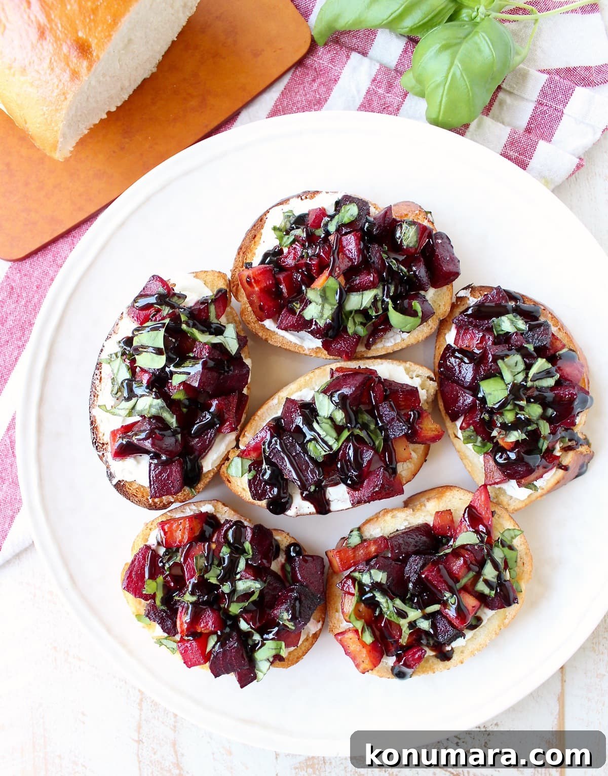 A toasted baguette is topped with goat cheese, balsamic roasted beets, fresh basil & balsamic reduction in this vegetarian Beet Bruschetta recipe that's perfect for Spring!