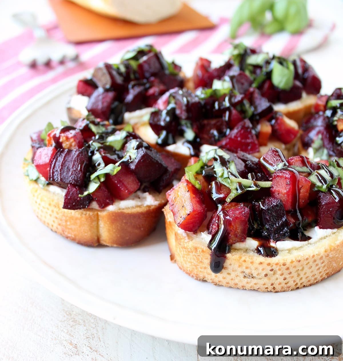 A toasted baguette is topped with goat cheese, balsamic roasted beets, fresh basil & balsamic reduction in this vegetarian Beet Bruschetta recipe that's perfect for Spring!