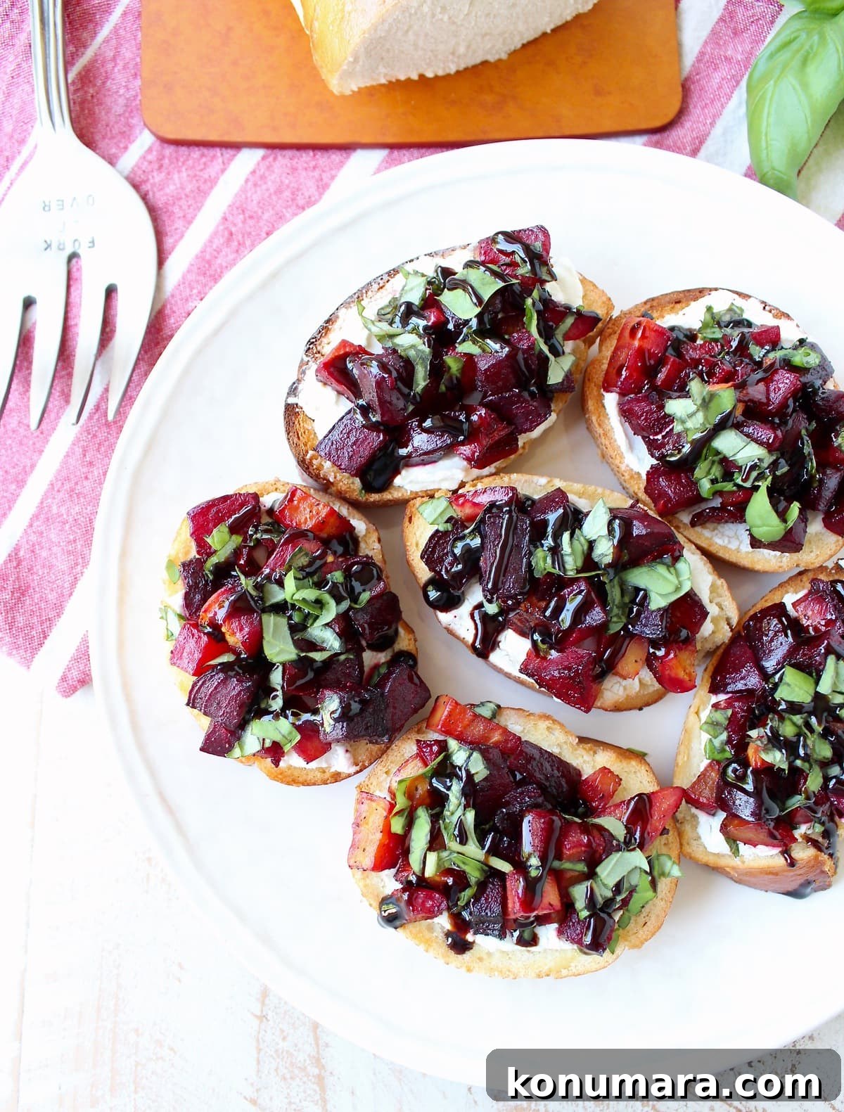 A toasted baguette is topped with goat cheese, balsamic roasted beets, fresh basil & balsamic reduction in this vegetarian Beet Bruschetta recipe that's perfect for Spring!