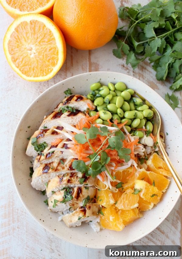 Flavorful Asian Chicken Rice Bowls for Quick Weeknight Meals 2 Sesame ginger marinated & grilled chicken tops these Healthy Asian Chicken Rice Bowls filled with oranges, almonds, veggies & tons of flavor!
