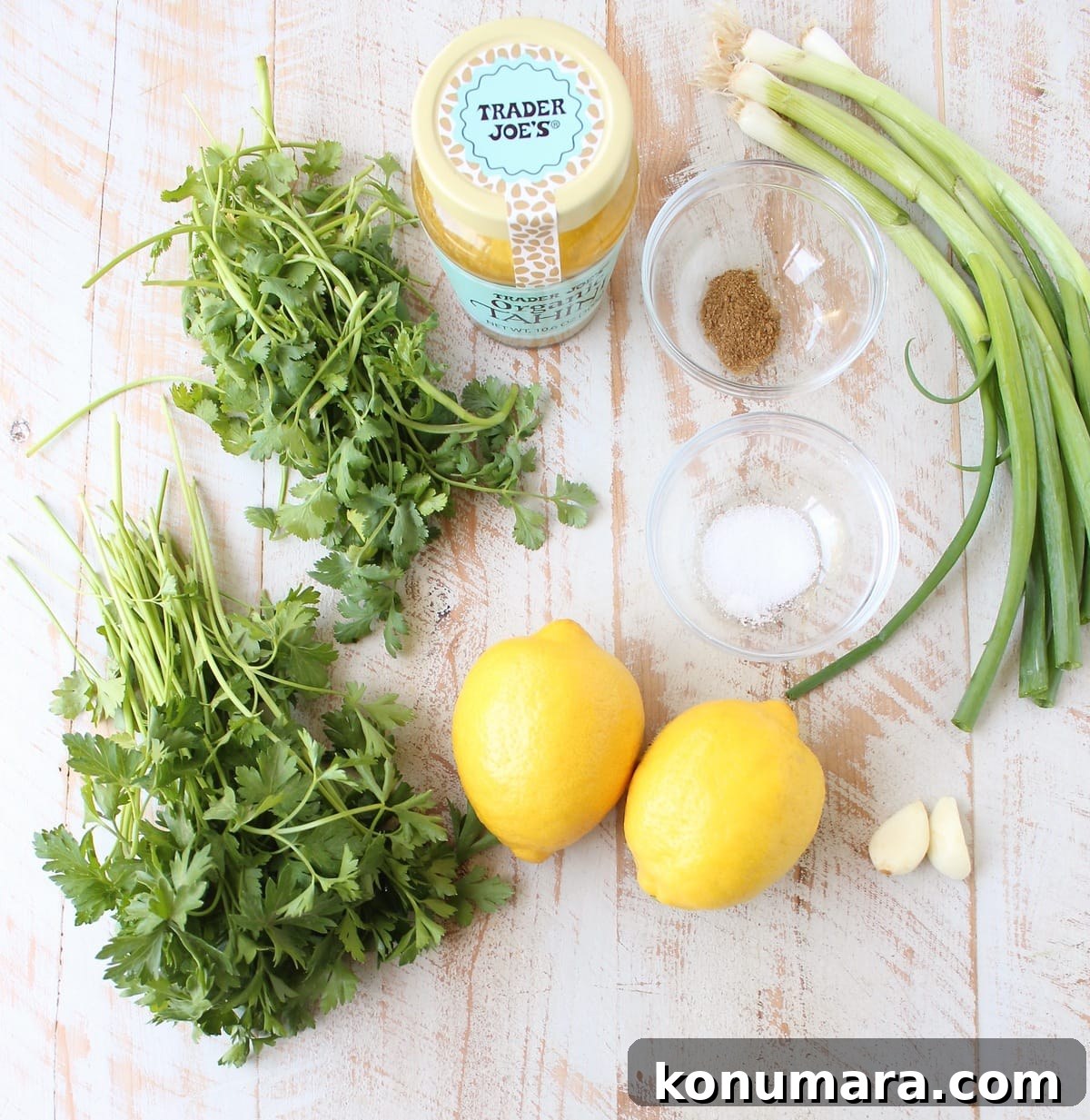 Green tahini sauce in a small bowl with herbs
