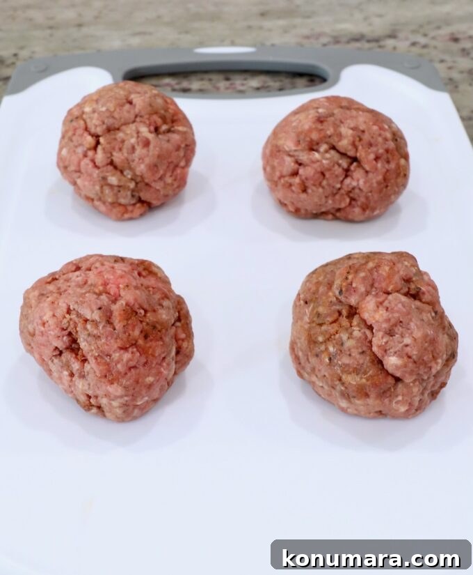 balls of ground beef on cutting board