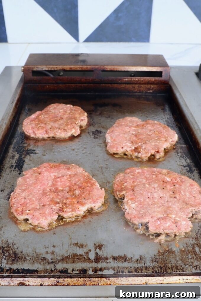 smashed burger patties on griddle