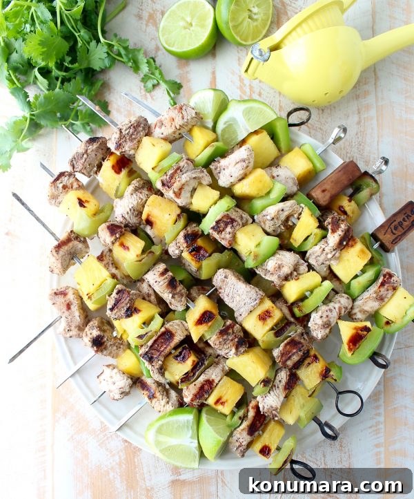 Jerk chicken kabobs with pineapple and bell peppers, the perfect 5-ingredient, gluten free recipe to toss on the grill and serve with honey lime sauce!