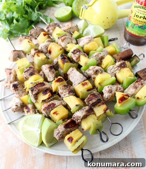 Jerk chicken kabobs with pineapple and bell peppers, the perfect 5-ingredient, gluten free recipe to toss on the grill and serve with honey lime sauce!