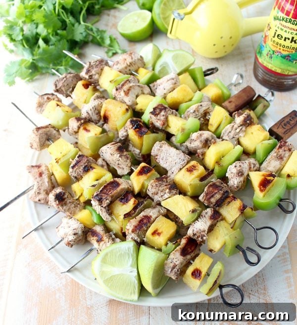 Jerk chicken kabobs with pineapple and bell peppers, the perfect 5-ingredient, gluten free recipe to toss on the grill and serve with honey lime sauce!