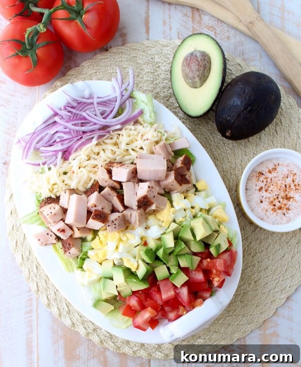 Spicy Cajun Turkey Cobb Salad Recipe 6 Close up of salad ingredients: avocado, eggs, tomatoes and Cajun turkey