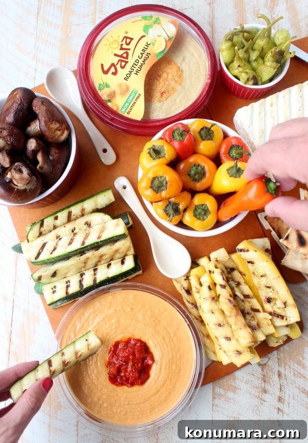 Mediterranean Grilled Vegetables and Hummus Platter 2 Mediterranean grilled vegetables, pita bread & feta cheese are served with an assortment of flavored hummus on this delicious veggie & hummus plate!