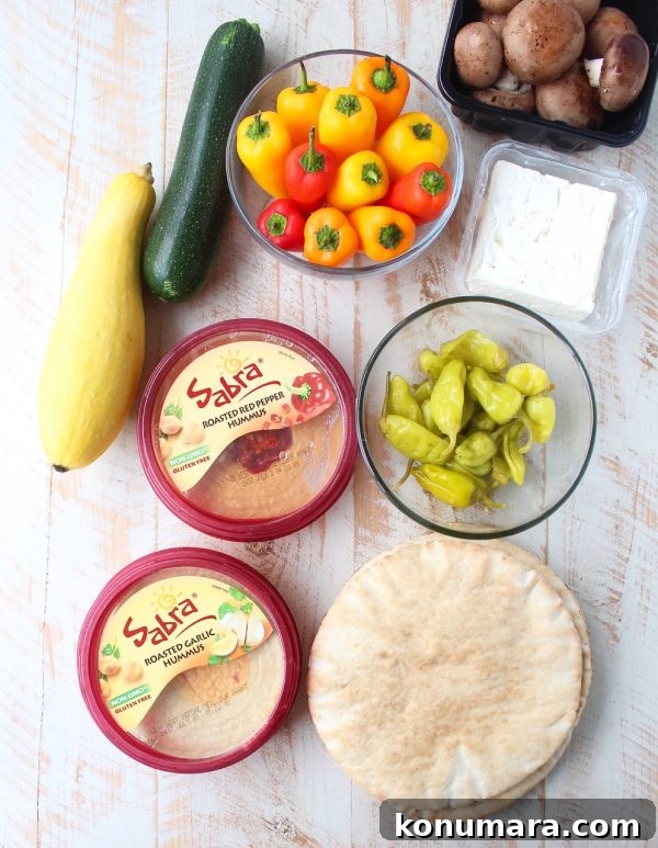Mediterranean Grilled Vegetables and Hummus Platter 4 Mediterranean grilled vegetables, pita bread & feta cheese are served with an assortment of flavored hummus on this delicious veggie & hummus plate!