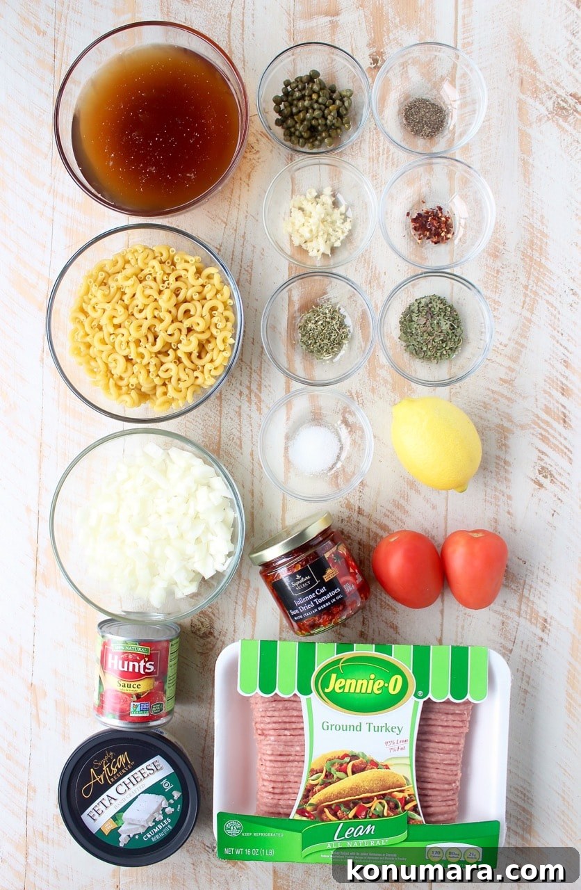 One-Pot Greek Pasta with Feta, Olives and Tomatoes 3 Ingredients for one pot Greek pasta on white wood board