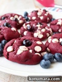 Red Velvet Cookies are filled with white chocolate chips and blueberries