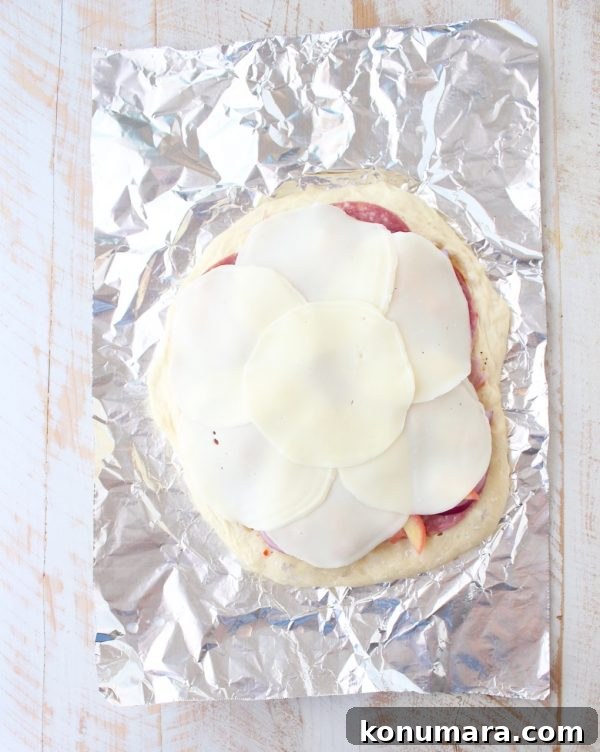 Italian Sub Pizza Recipe: Loaded Meats, Provolone and Herbs 6 All of the ingredients in a traditional Italian Sub, like salami, pepperoni & provolone, top this delicious Italian Sub Pizza Recipe, easily made in under 30 minutes in the oven or on the grill!