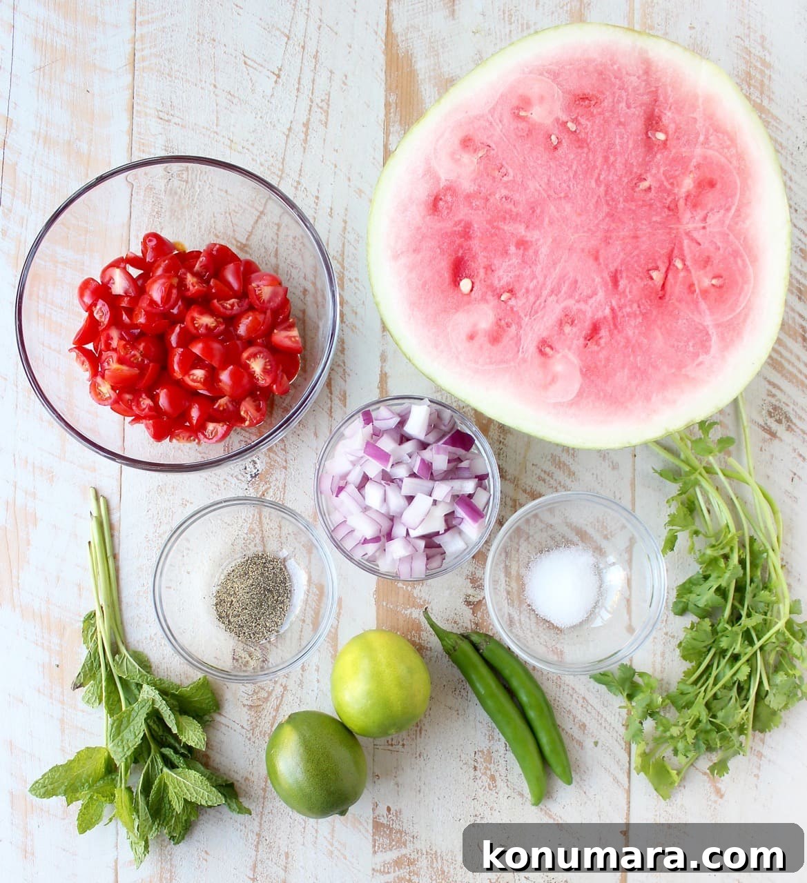 watermelon salsa ingredients on white wood board
