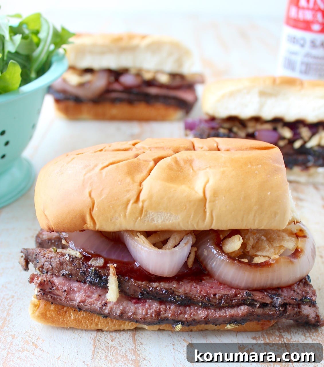 grilled steak sandwiches on white wood board