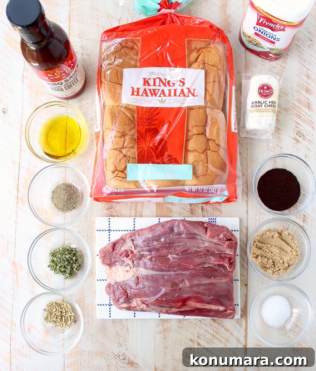 ingredients for steak sandwiches on white wood board