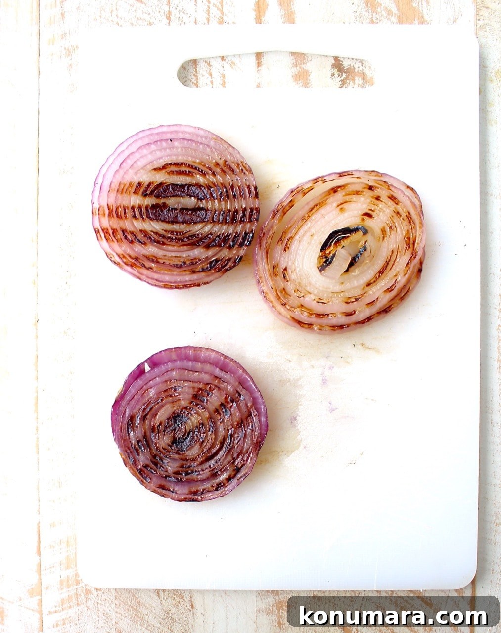 grilled slices of onions on cutting board