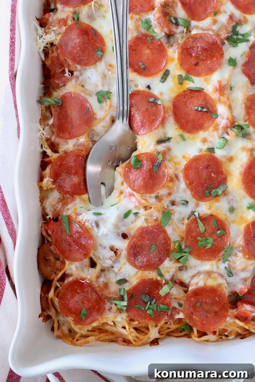 Baked Spaghetti Pizza Recipe 2 pizza baked spaghetti in casserole dish with large serving fork