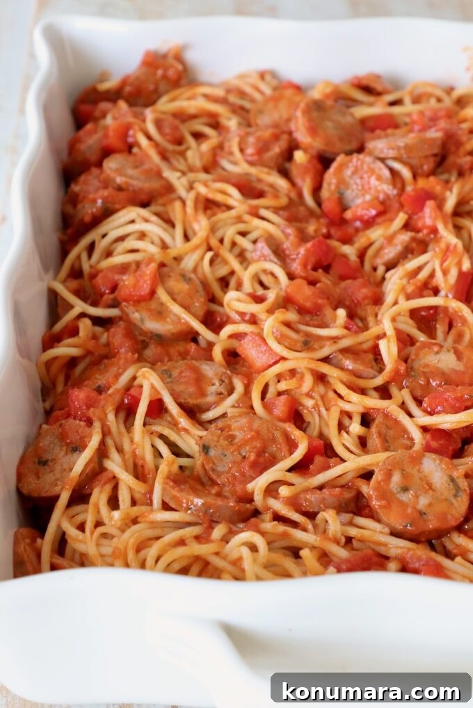 Baked Spaghetti Pizza Recipe 5 cooked spaghetti tossed with marinara sauce, sausage and peppers in casserole dish