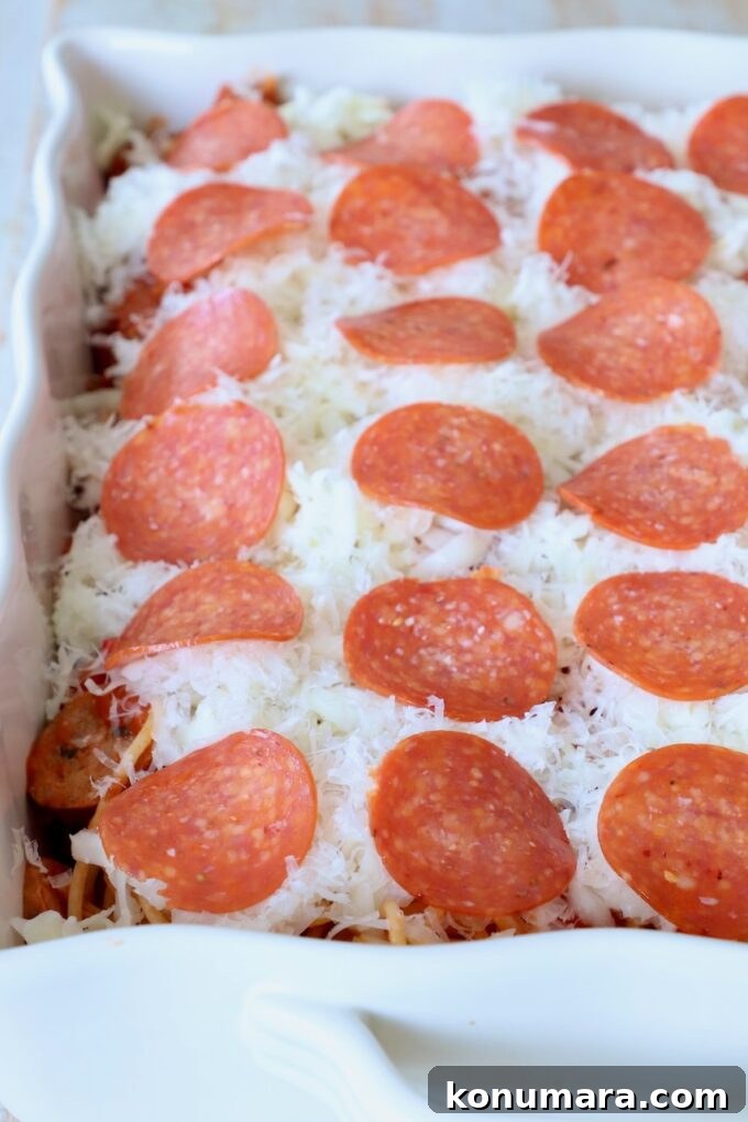 Baked Spaghetti Pizza Recipe 7 uncooked spaghetti casserole topped with shredded cheese and slices of pepperoni