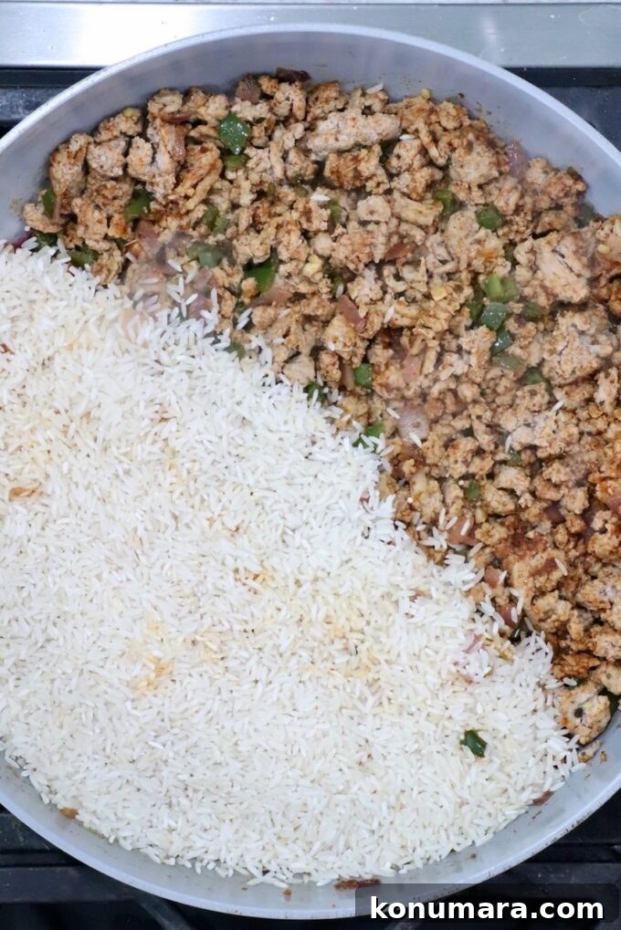 cooked, seasoned ground turkey in a skillet with white rice