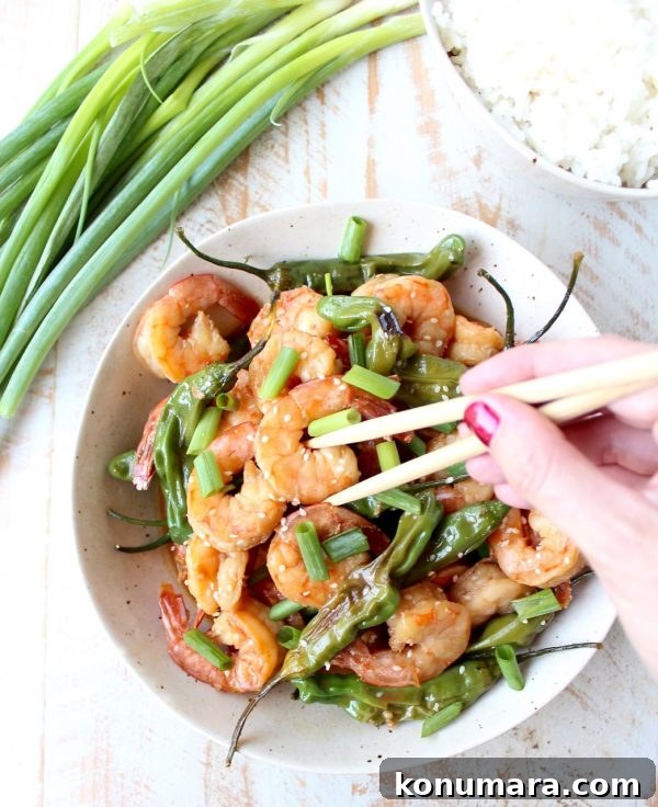 Shrimp and shishito peppers in a skillet