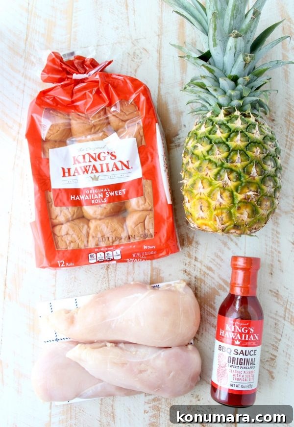 Hawaiian Chicken Sliders are easily made by tossing chicken, pineapple & Hawaiian BBQ sauce in a slow cooker for a few hours, then serving on Hawaiian rolls!