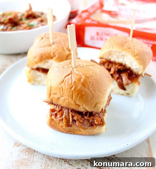 Hawaiian Chicken Sliders are easily made by tossing chicken, pineapple & Hawaiian BBQ sauce in a slow cooker for a few hours, then serving on Hawaiian rolls!