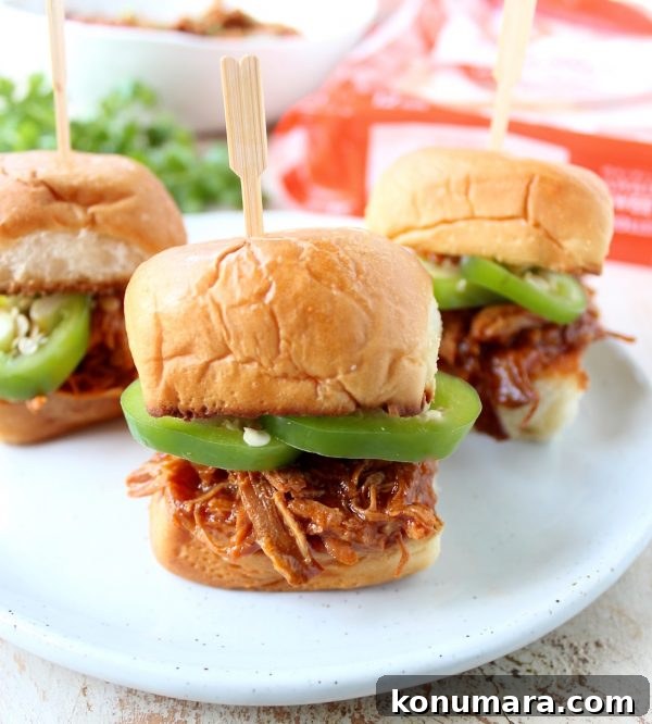 Hawaiian Chicken Sliders are easily made by tossing chicken, pineapple & Hawaiian BBQ sauce in a slow cooker for a few hours, then serving on Hawaiian rolls!