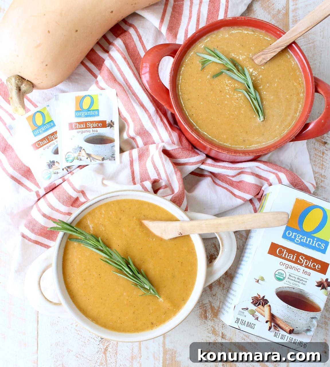 Butternut squash soup in bowls topped with fresh rosemary sprigs