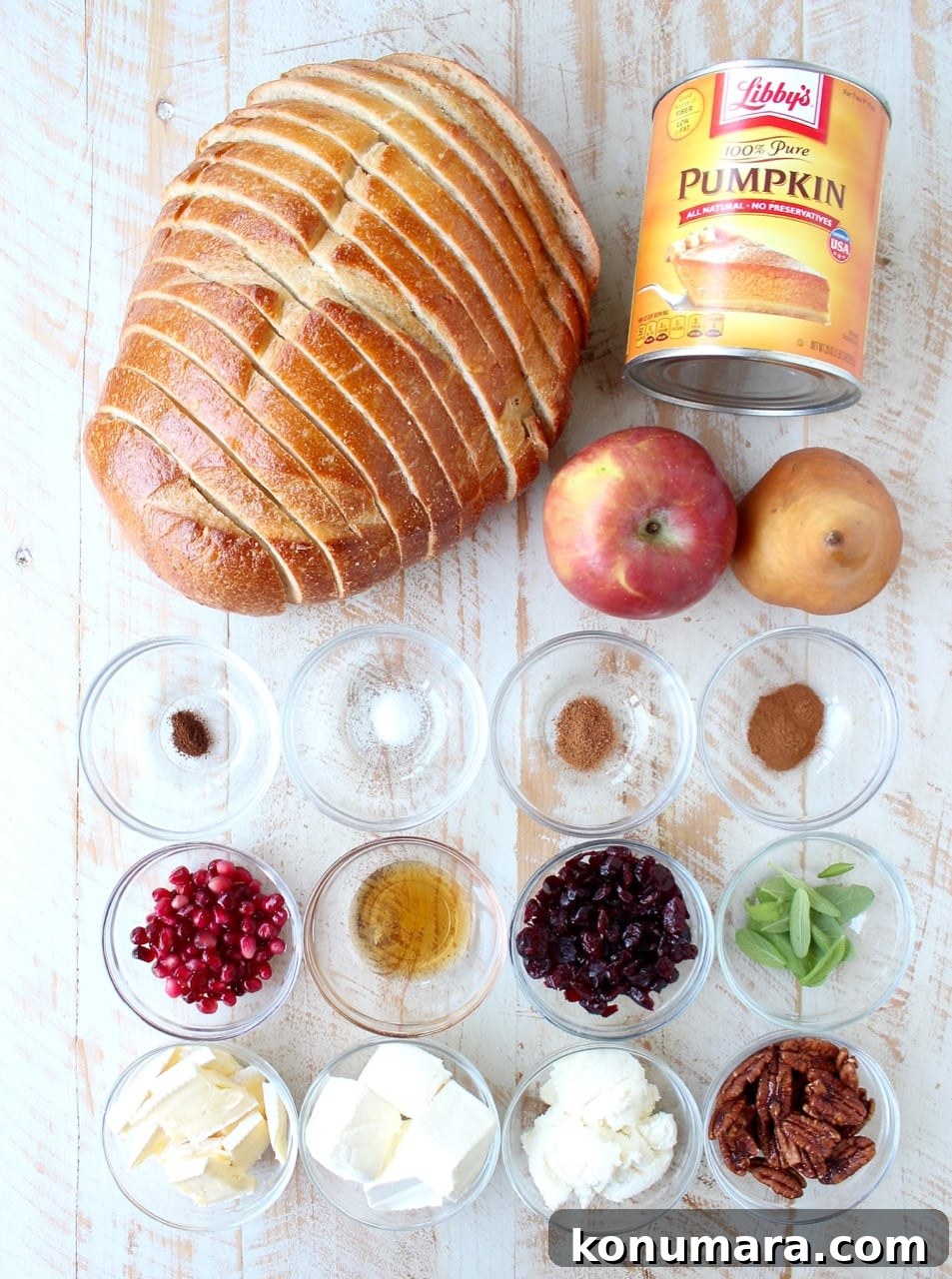 pumpkin toast ingredients and toppings on a white wood board