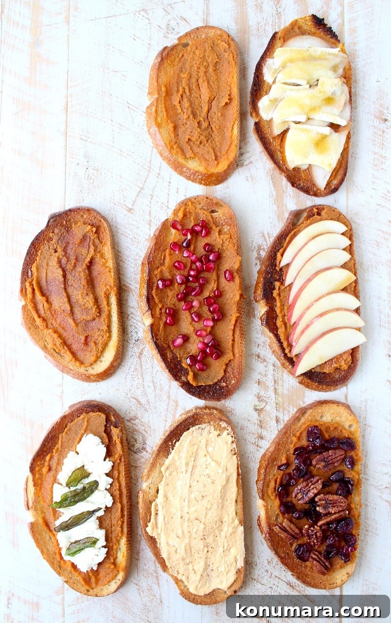 seven slices of pumpkin toast on a white wood board with various toppings