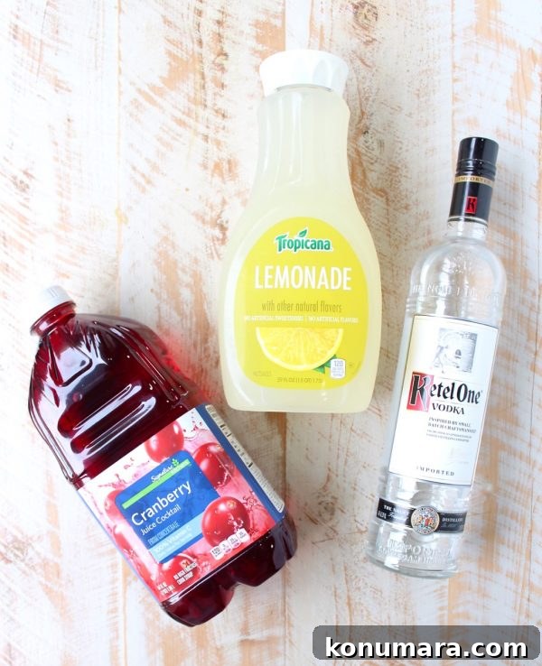 Glass of spiked cranberry lemonade with rosemary garnish