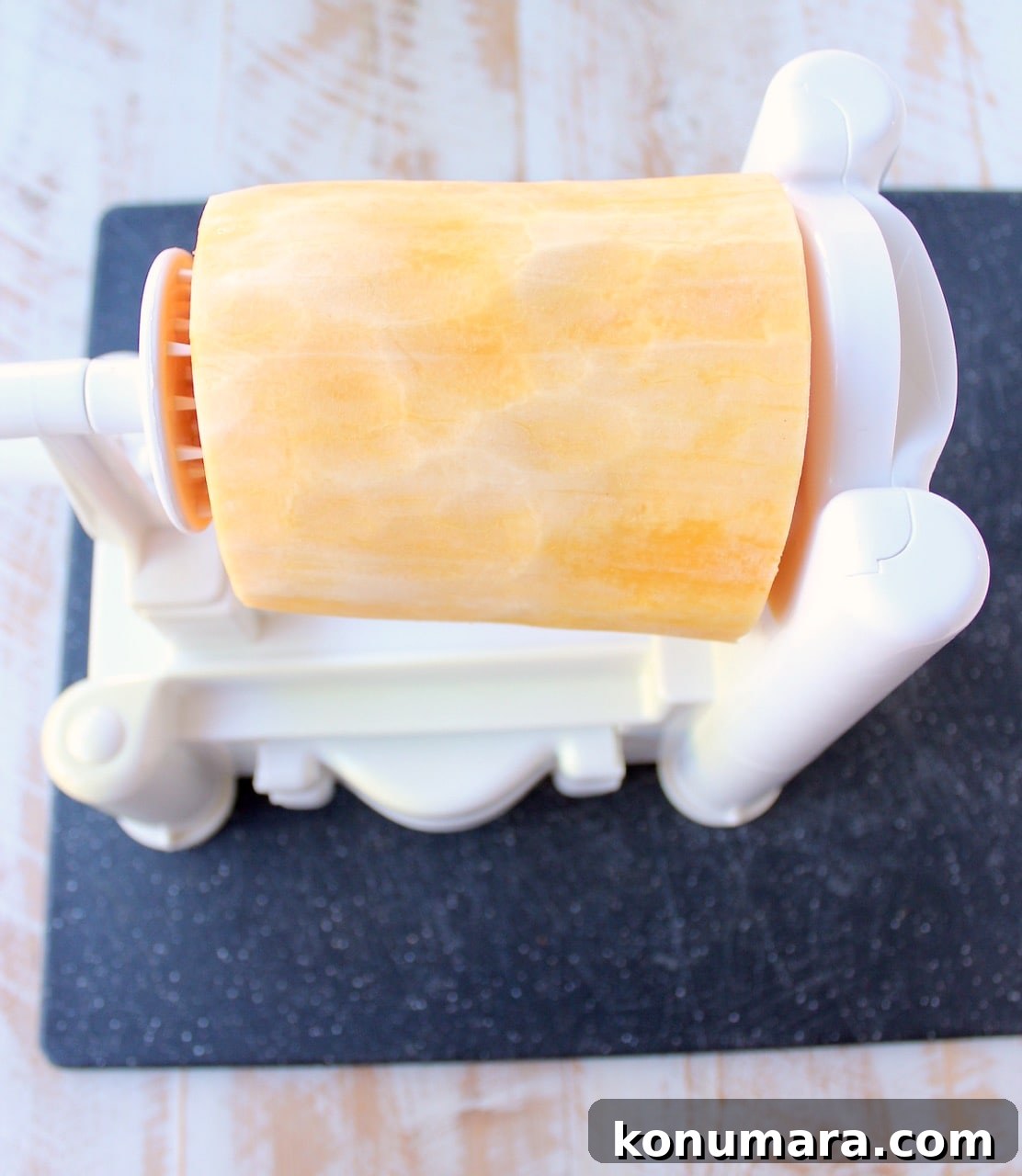 peeled butternut squash in a spiralizer machine