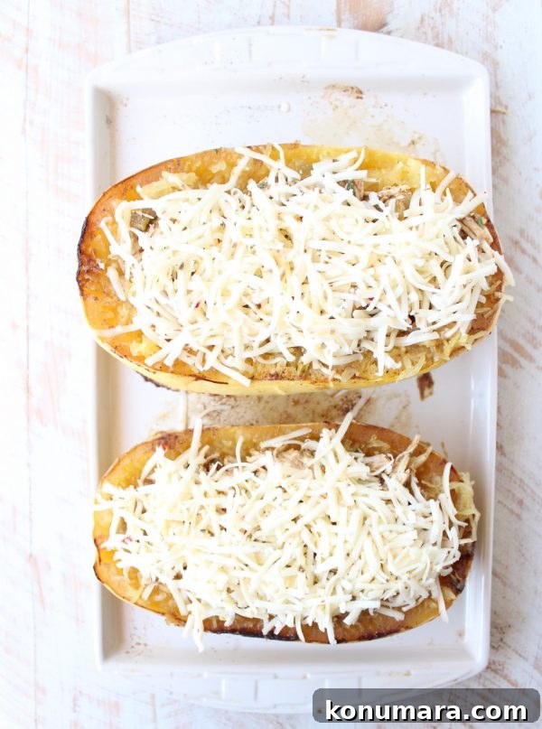 roasted spaghetti squash cut in half topped with shredded cheese