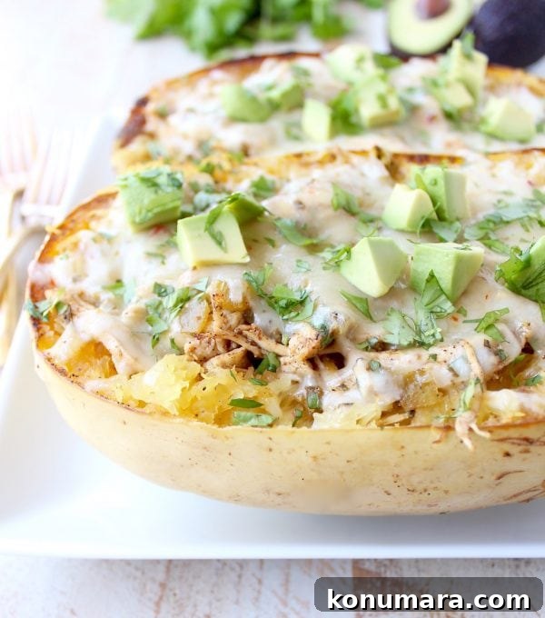 Green chili chicken spaghetti squash on plate topped with diced avocado