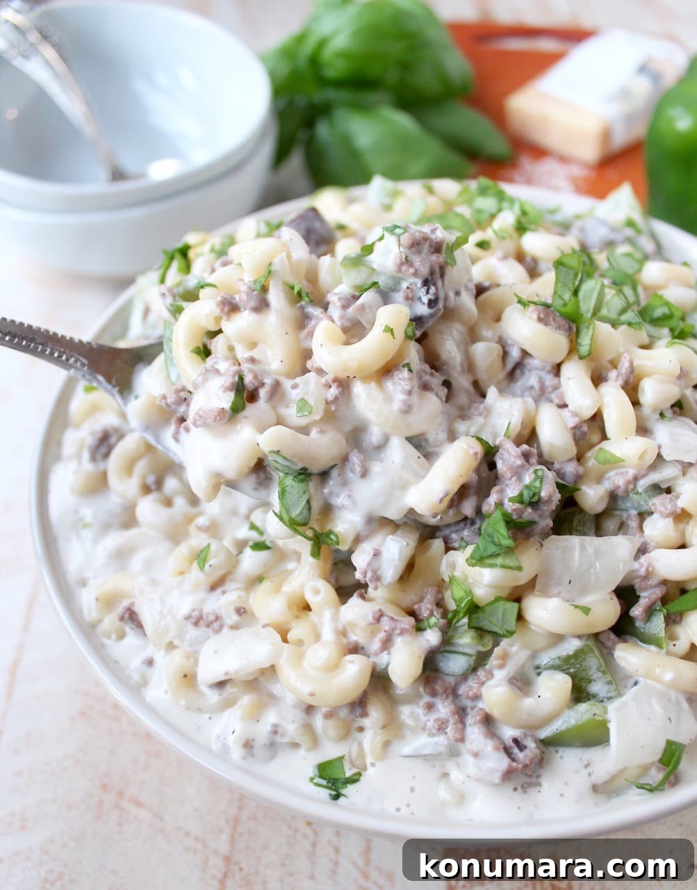 Loaded Philly Cheesesteak Mac and Cheese 7 prepared cheesesteak mac and cheese in bowl with serving spoon
