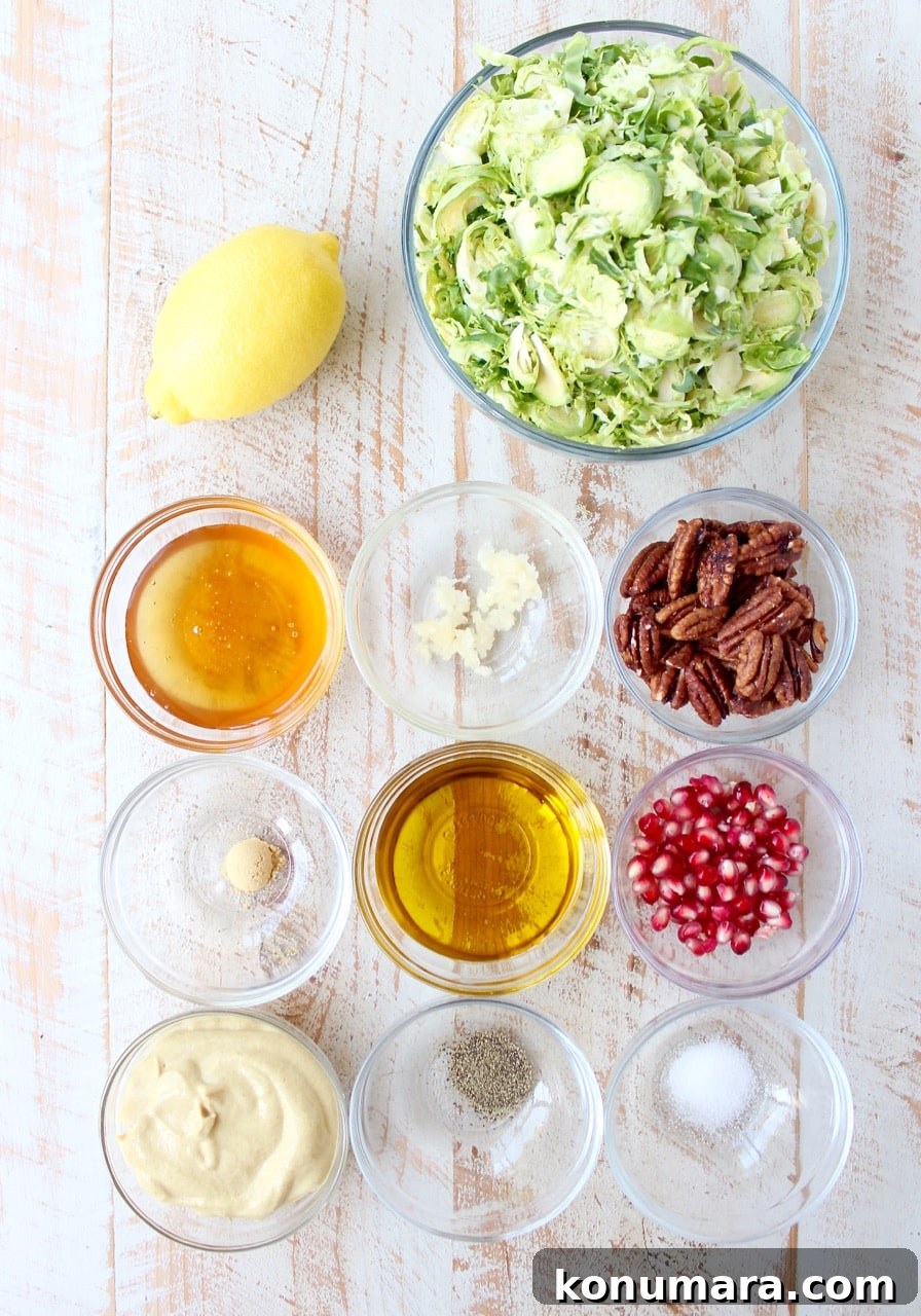 ingredients for brussels sprouts salad on white wood board