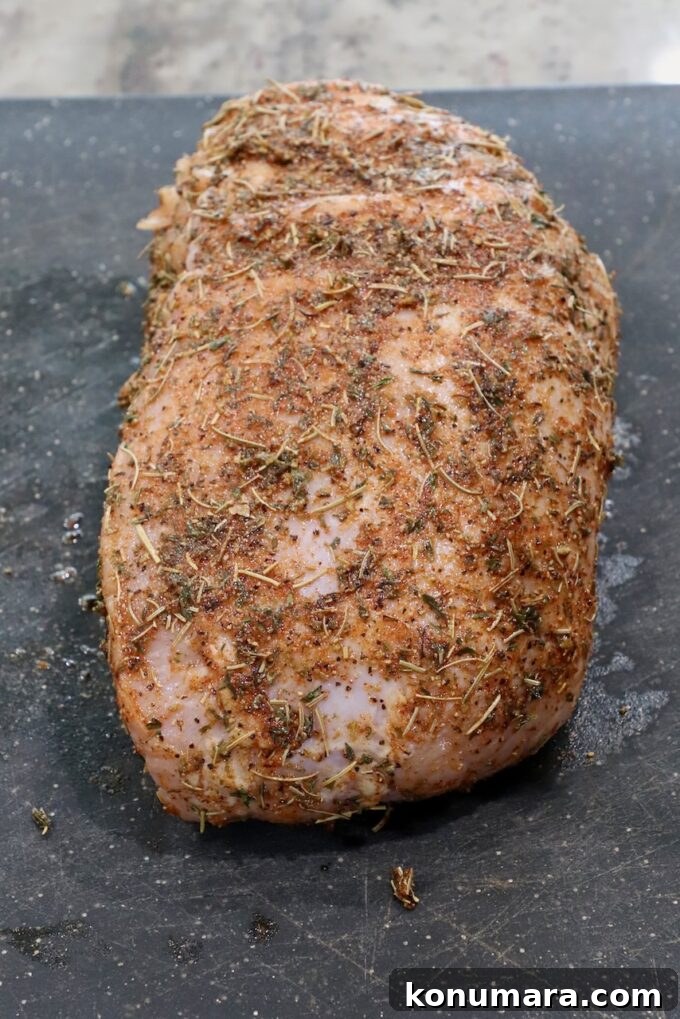 Juicy Slow-Cooker Turkey Breast Recipe 4 seasoned turkey breast on a cutting board