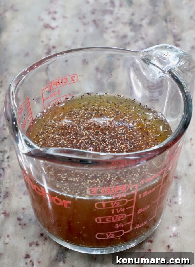 Juicy Slow-Cooker Turkey Breast Recipe 5 maple syrup and apple cider combined in a glass measuring cup with salt and pepper