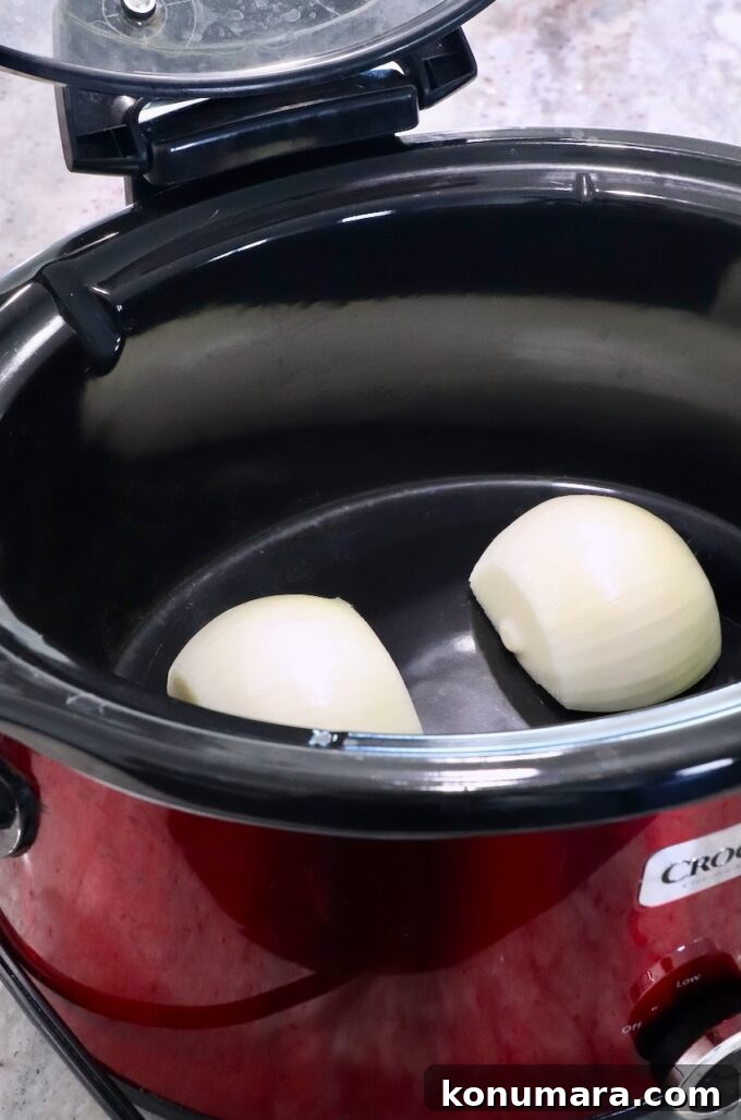 Juicy Slow-Cooker Turkey Breast Recipe 6 onion cut in half in a crock pot