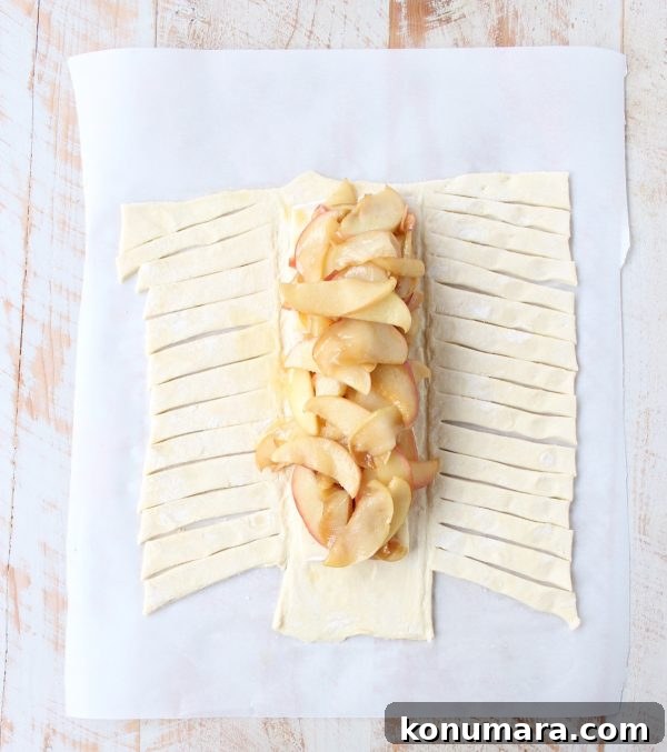 Brie-Stuffed Apple Strudel Recipe 4 Sliced apple strudel with melted brie inside.