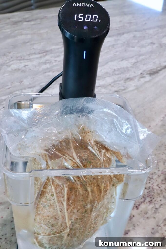 Juicy Sous-Vide Turkey Breast Recipe 5 vacuum sealed turkey breast in a water bath with a sous vide on the side