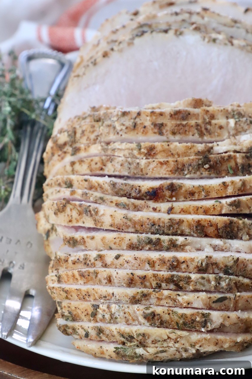 Juicy Sous-Vide Turkey Breast Recipe 6 sliced turkey breast on a plate with a large serving fork