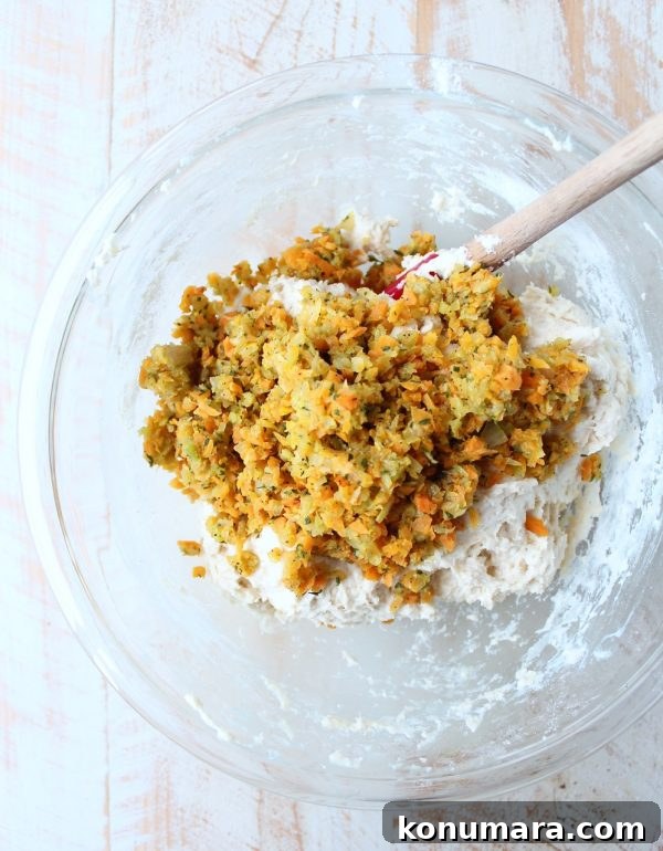 Stuffed Biscuits Recipe: Savory Filling Ideas 6 minced vegetables in a bowl of biscuit dough with a spatula