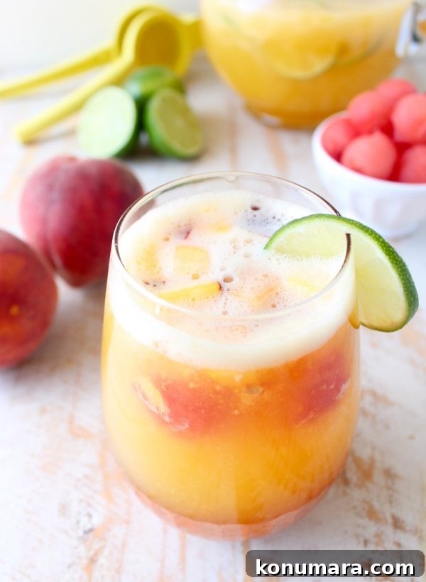 This white peach sangria is the perfect summer cocktail recipe combining refreshing white wine with fresh peaches, nectarines and lime juice!