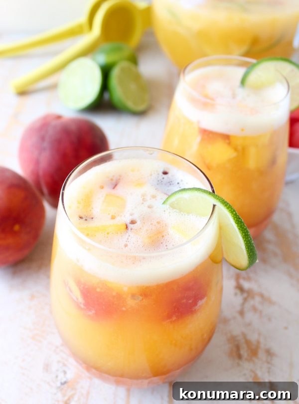 This white peach sangria is the perfect summer cocktail recipe combining refreshing white wine with fresh peaches, nectarines and lime juice!